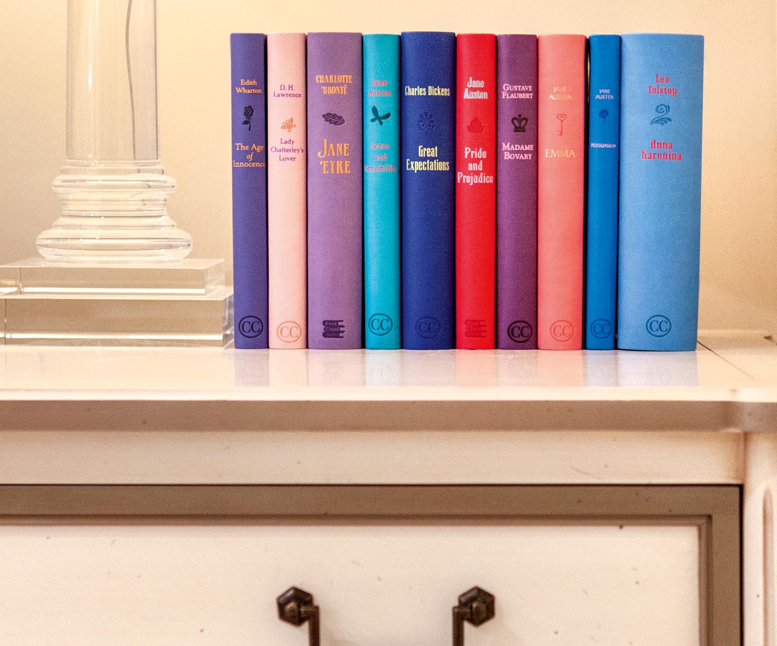 Photo of a collection of colorful books above a drawer.