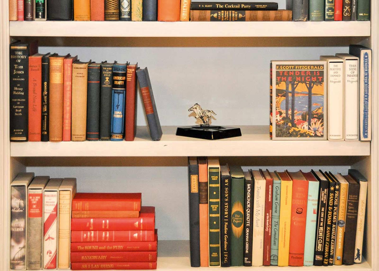 Photo of aged books collected on shelves.