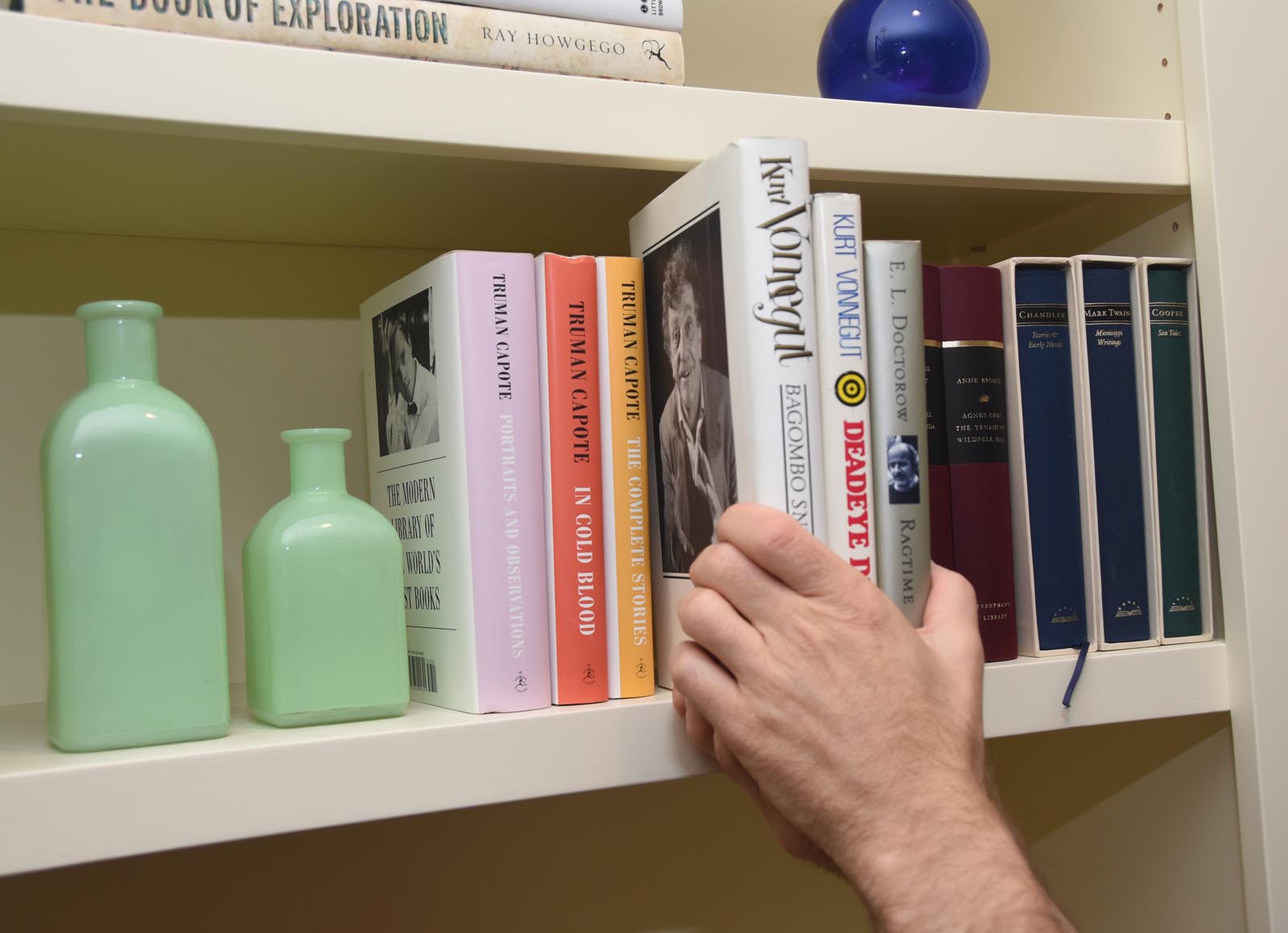 Photo of replacing books next to the bottles.