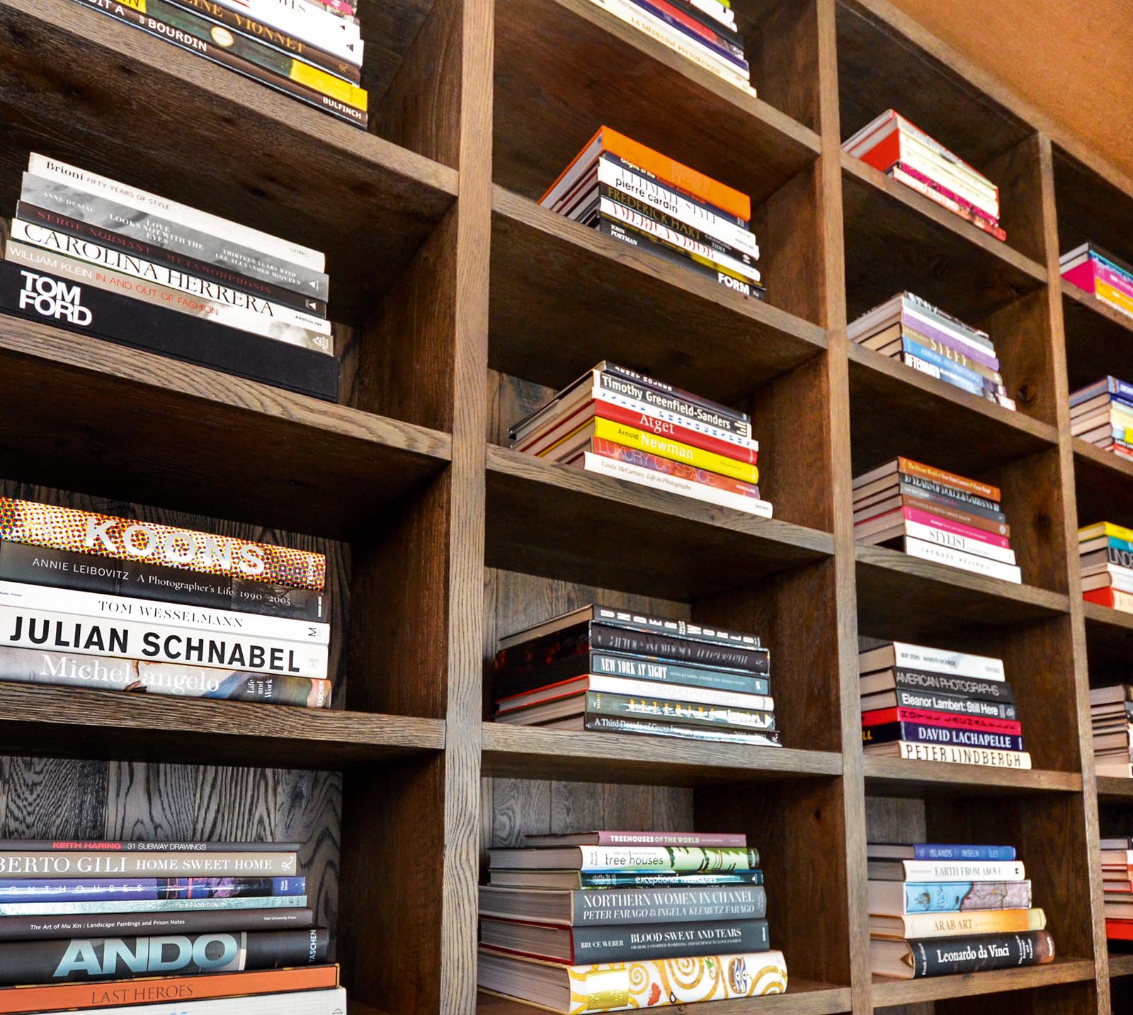 Photo of stacks of books symetrically arranged in small shelf spaces.