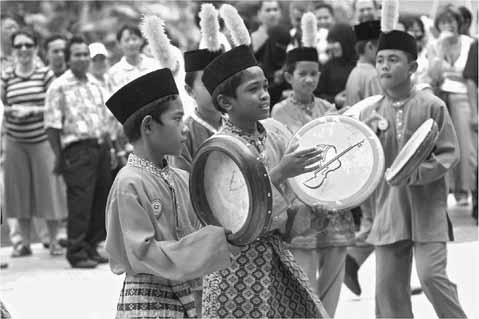 Figure 4.1 Malaysian boys in traditional dress playing the kompang. Photo by Universiti Teknologi MARA, Malaysia/ISME 2006.