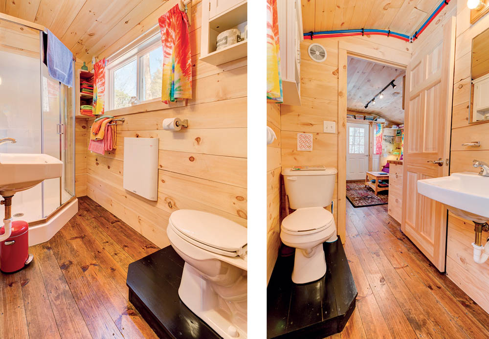 The bathroom with a toilet, sink, and shower in the Apple Blossom Cottage.