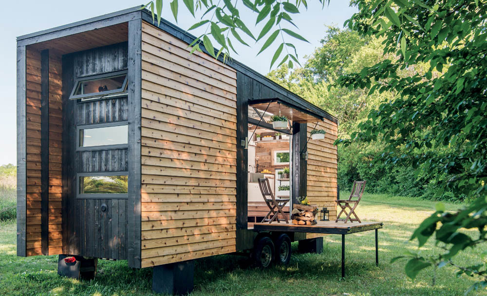 The exterior of the Alpha Tiny House with a drop down deck.