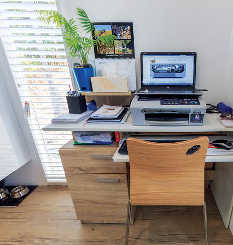 A computer desk setup in the IQ Container tiny house.