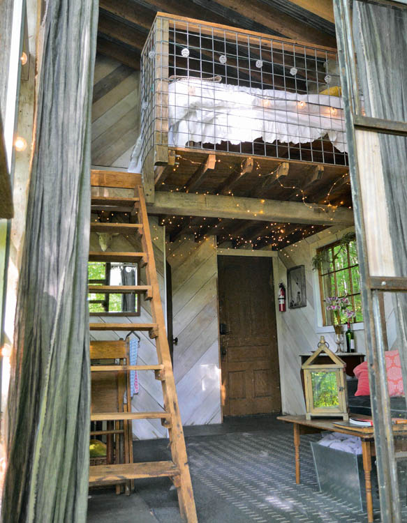 The living room and sleeping loft in the Luna Loft treehouse.