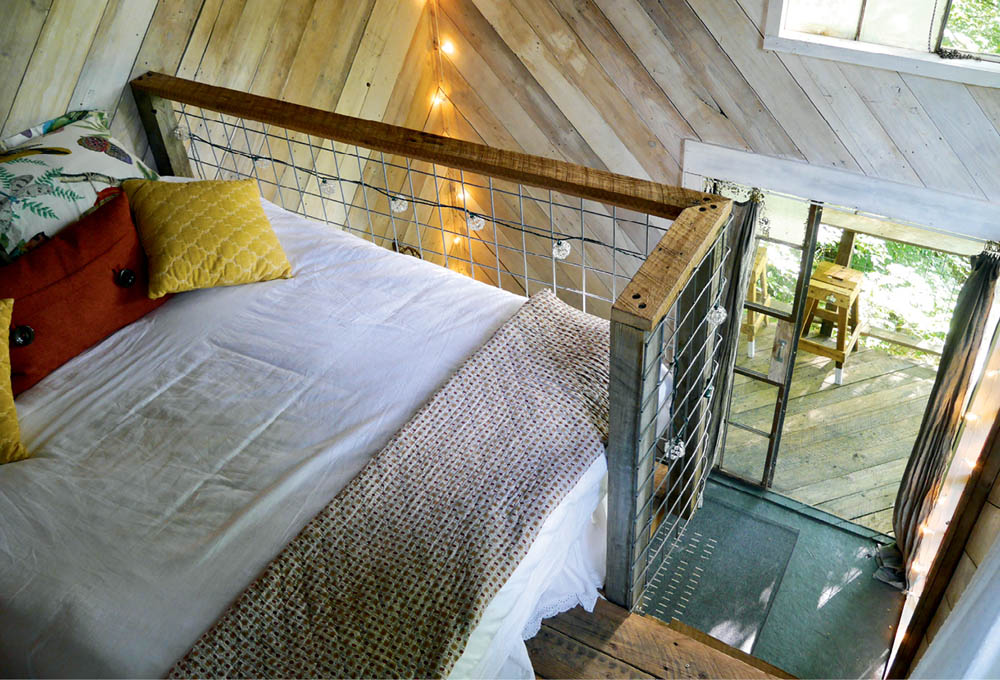 The bed in the sleeping loft of the Luna Loft treehouse.