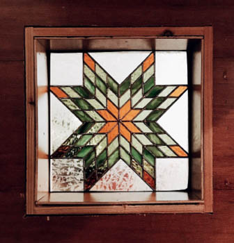 A stained glass window in the Turtleback tiny house.