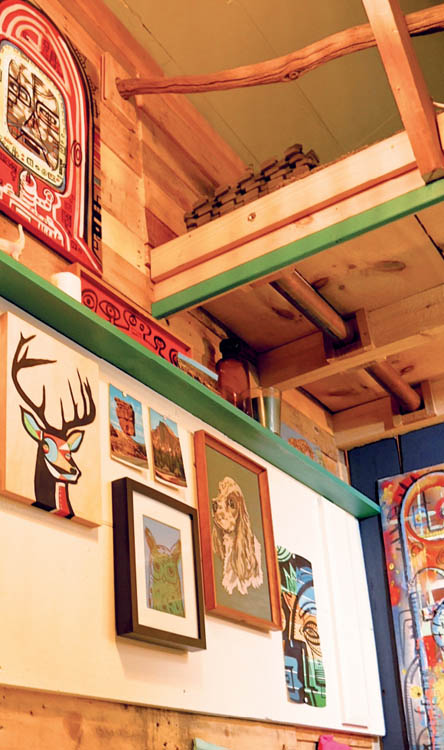 The walls adorned with artwork in the Pallet House tiny house.