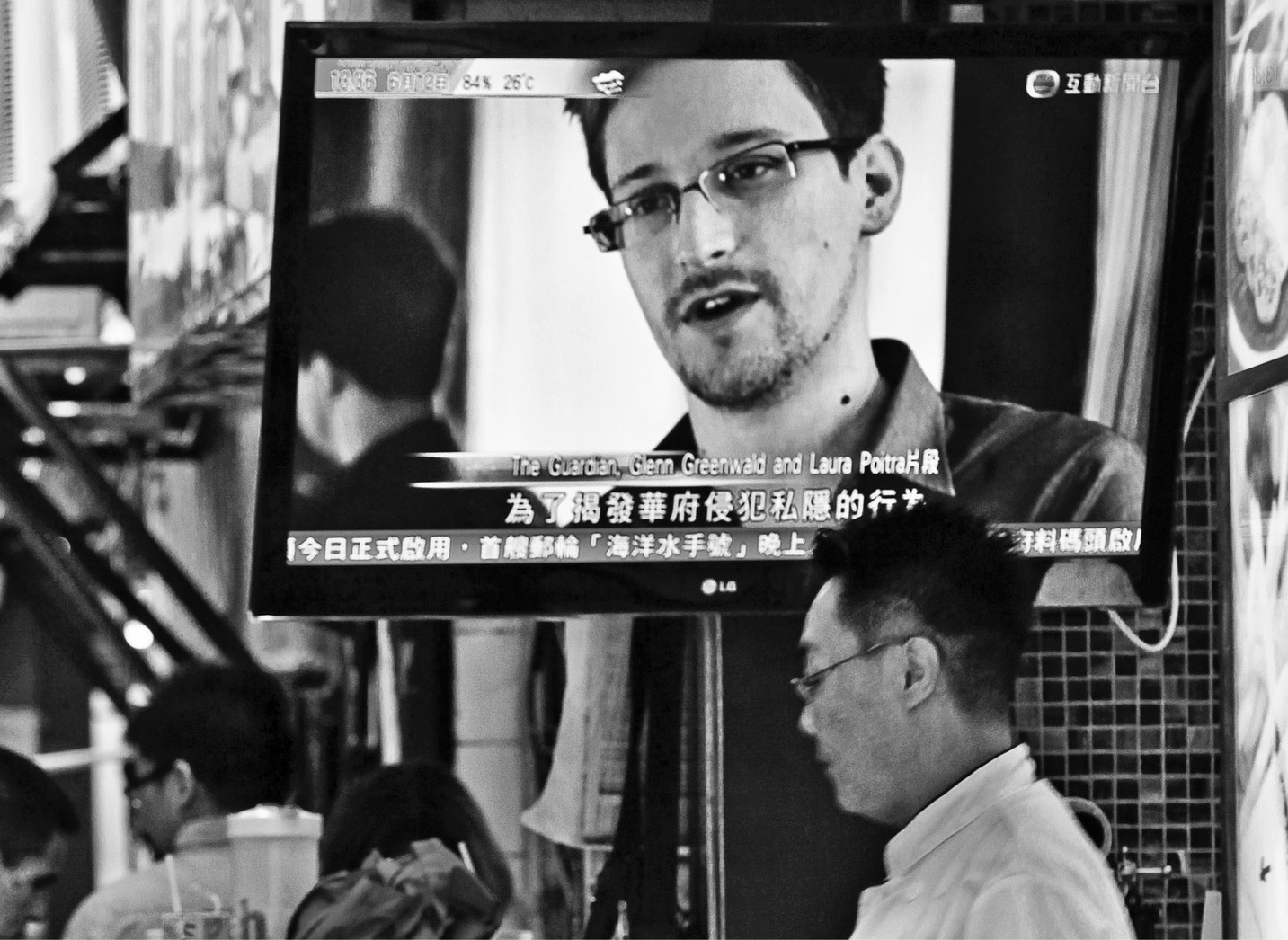 A TV screen shows the news of Edward Snowden, former CIA employee who leaked top-secret documents about sweeping U.S. surveillance programs, at a restaurant in Hong Kong Wednesday, June 12, 2013. The whereabouts of Snowden remained unknown Wednesday, two days after he checked out of a Hong Kong hotel. (AP Photo/Kin Cheung)