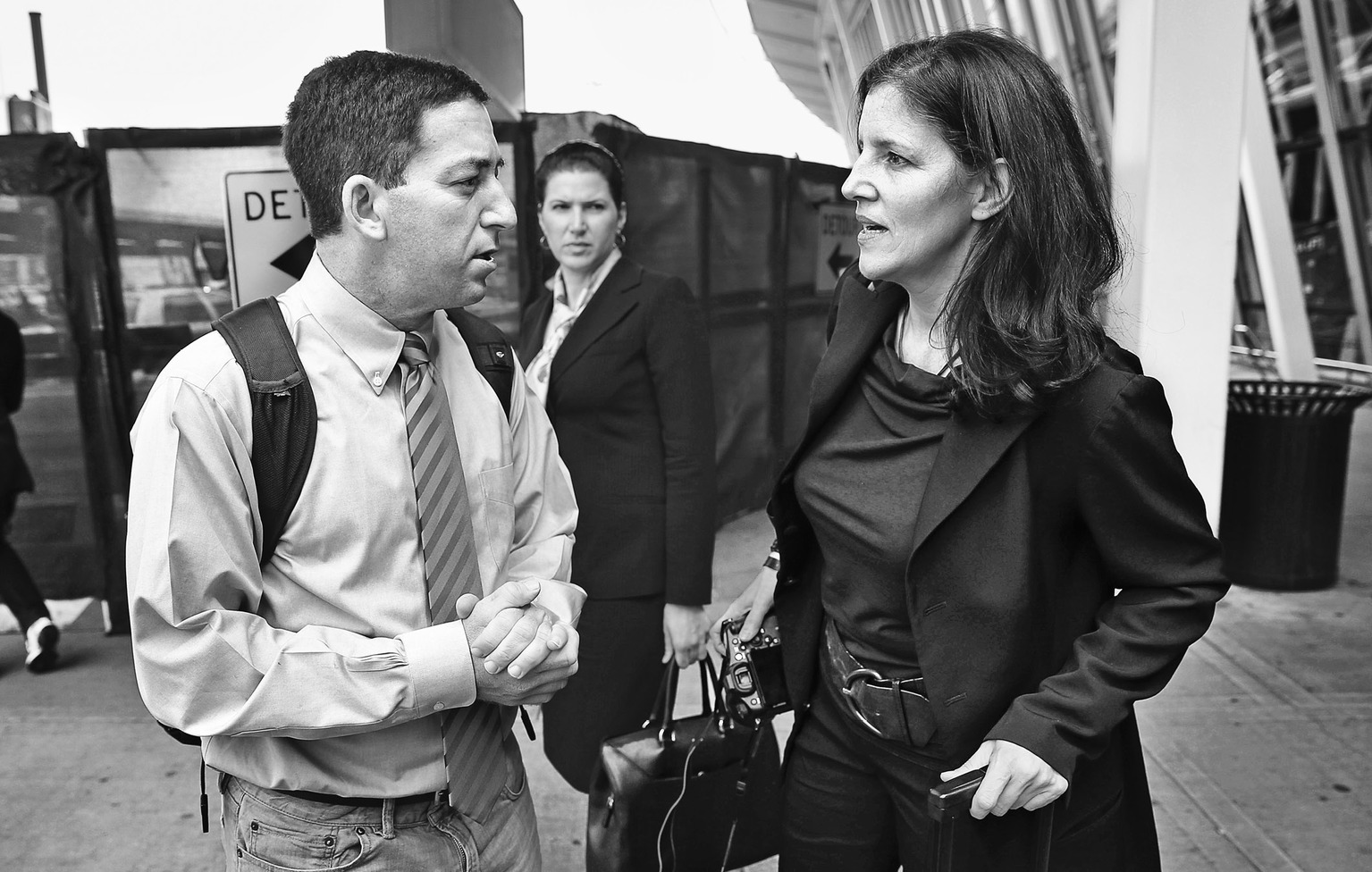 Glenn Greenwald, left, and Laura Poitras arrive at at John F. Kennedy International Airport, Friday, April 11, 2014 in New York.  Greenwald and Poitras share a George Polk Award for national security reporting with The Guardian's Ewen MacAskill and Barton Gellman, who has led The Washington Post's reporting on the NSA documents.  (AP Photo/John Minchillo)