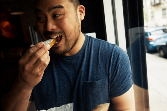 David Chang biting into a pastry