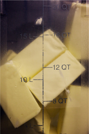 Tablespoons of butter seen through the side of a measuring cup