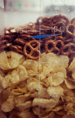 Pretzels and chips in a plastic container