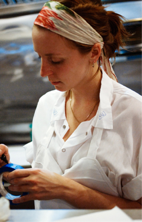 Christina Tosi writing on a roll of blue tape