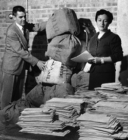 Braves ticket director William Ebberly and Marion Kleiner examined the World Series ticket applications that flooded County Stadium on the morning of September 18, 1957. They estimated that the post office had already delivered twenty-nine bags of mail, containing nearly 47,600 pieces. (MILWAUKEE JOURNAL SENTINEL)