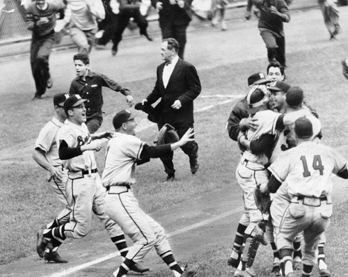 The victorious Braves hugged one another on the mound. Later they would cash World Series checks of $8,924.36 each. (NATIONAL BASEBALL HALL OF FAME LIBRARY)