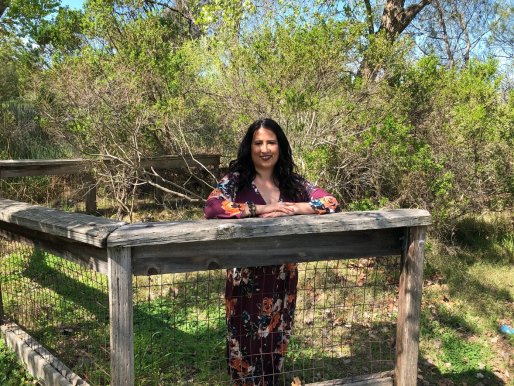 A person sitting on a wooden bench

Description automatically generated