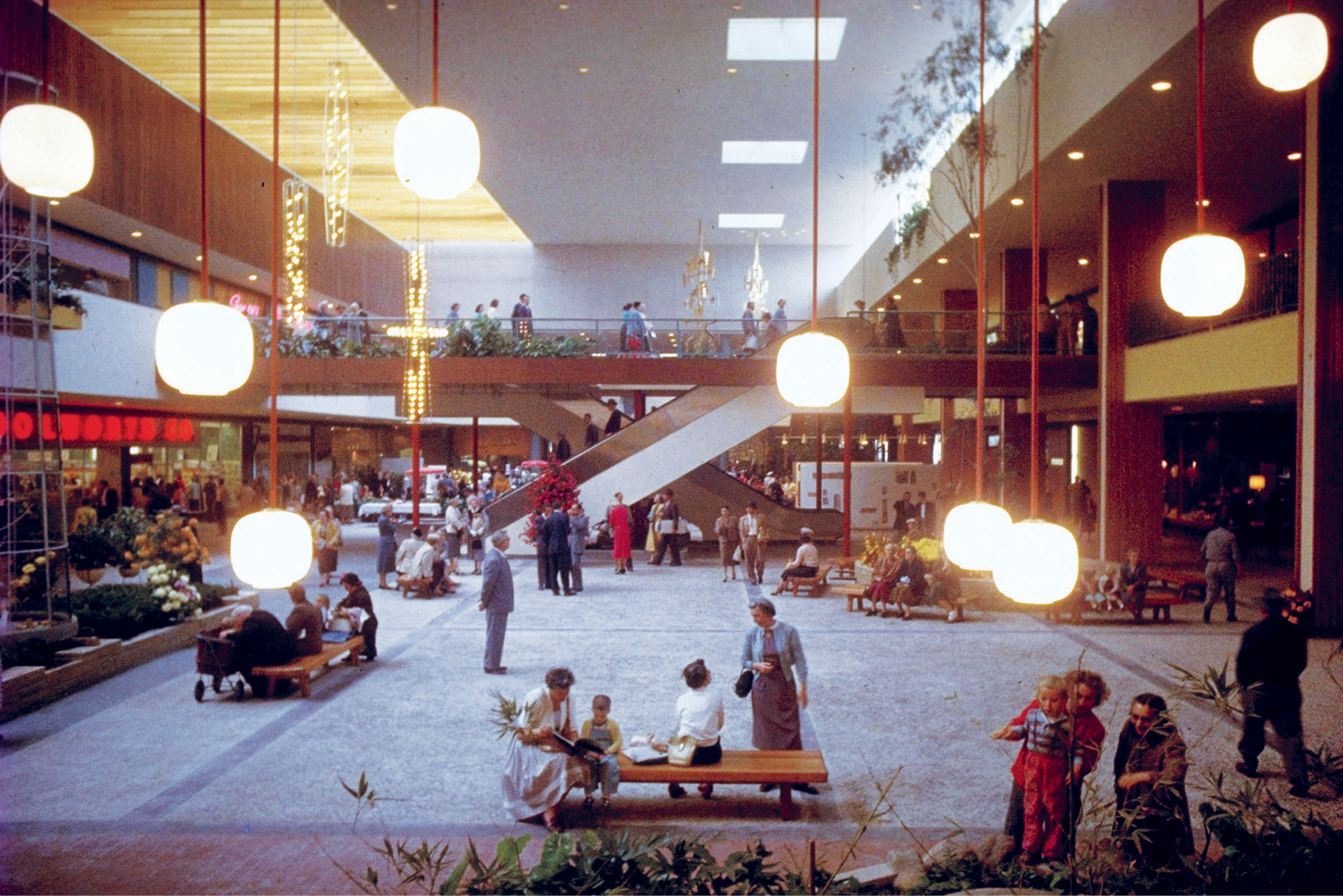  Shoppers in interior Garden Court w/ stairway to upper level in Southdale Regional Shopping Center, first indoor mall..  (Photo by Grey Villet/The LIFE Picture Collection/Getty Images)