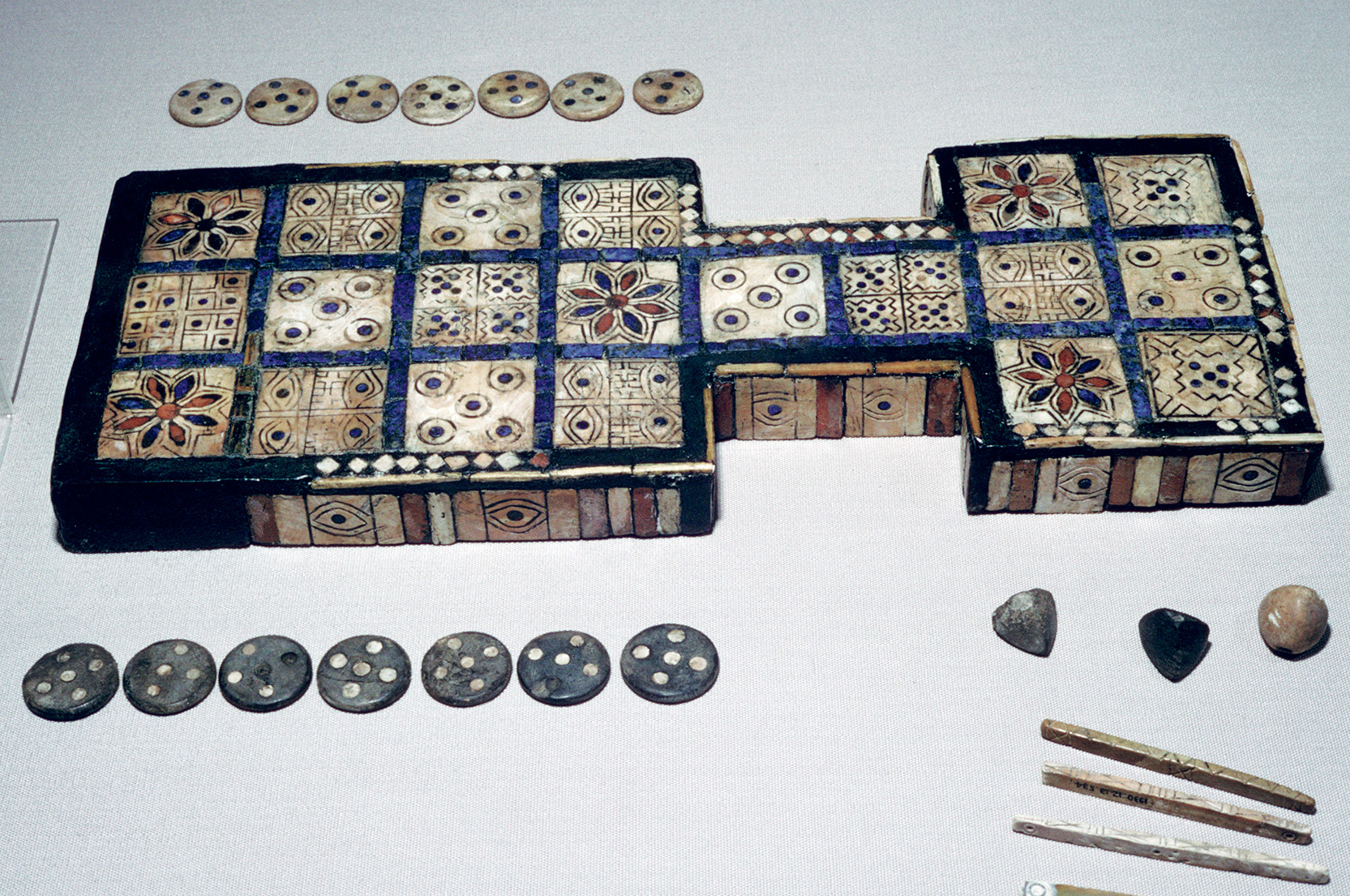  The Royal Game of Ur, from Ur, southern Iraq, c2600-c2400 BC. This game board is one of several with a similar layout found by Leonard Woolley in the Royal Cemetery at Ur. The board has twenty squares made of shell and was made for two players. Examples of this 'Game of Twenty Squares' date from about 3000 BC to the first millennium AD and are found widely from the eastern Mediterranean and Egypt to India. A version of the Mesopotamian game survived within the Jewish community at Cochin, South India until modern times. From the British Museum's collection. (Photo by CM Dixon/Print Collector/Getty Images)