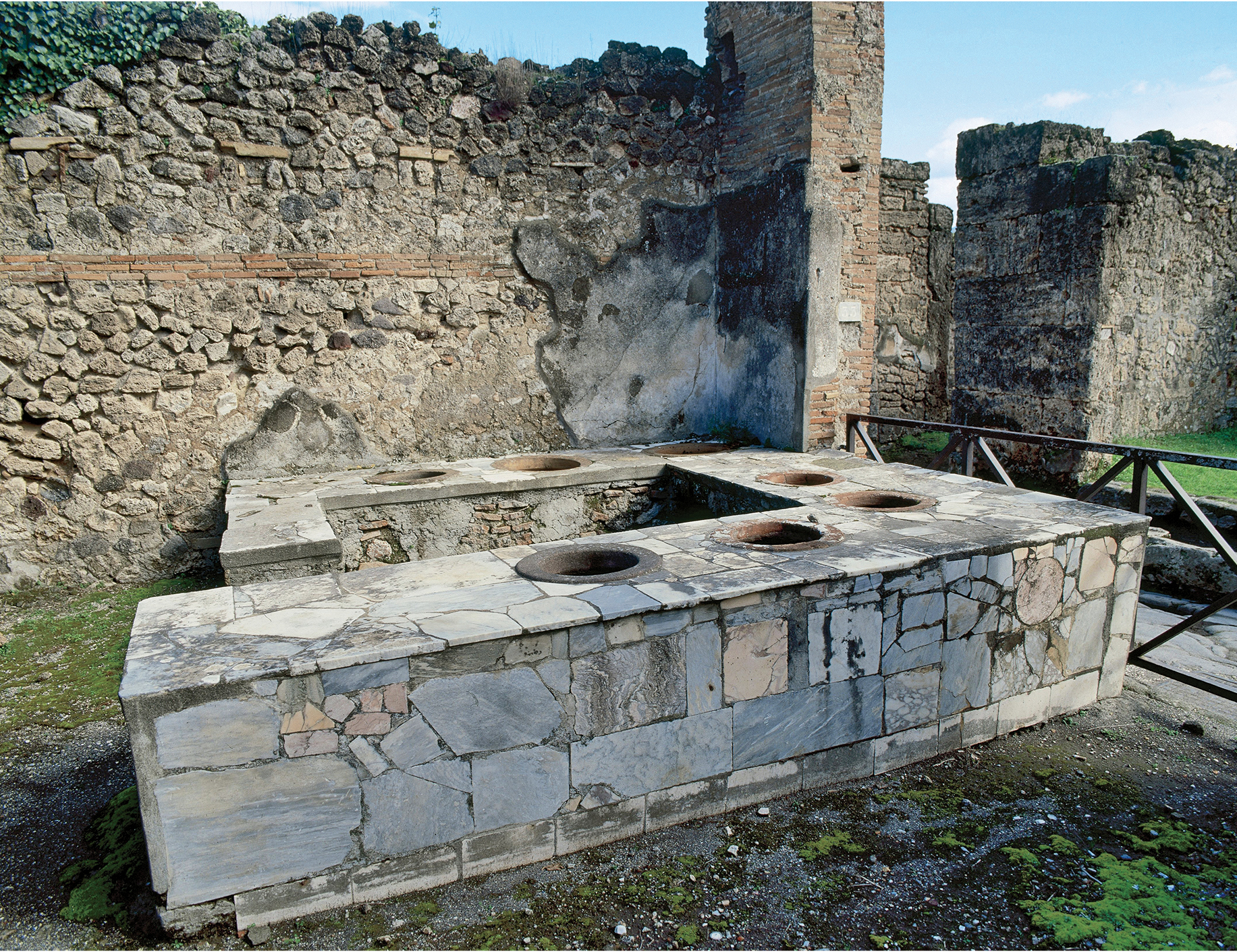  Thermopolium. Tavern specializing in the sale of hot beverages. Stone bar with holes to place the amphorae containing drinks. At the intersection of Via degli Augustali with Vico Storto. Pompeii. Italy. (Photo by: Prisma/UIG via Getty Images)