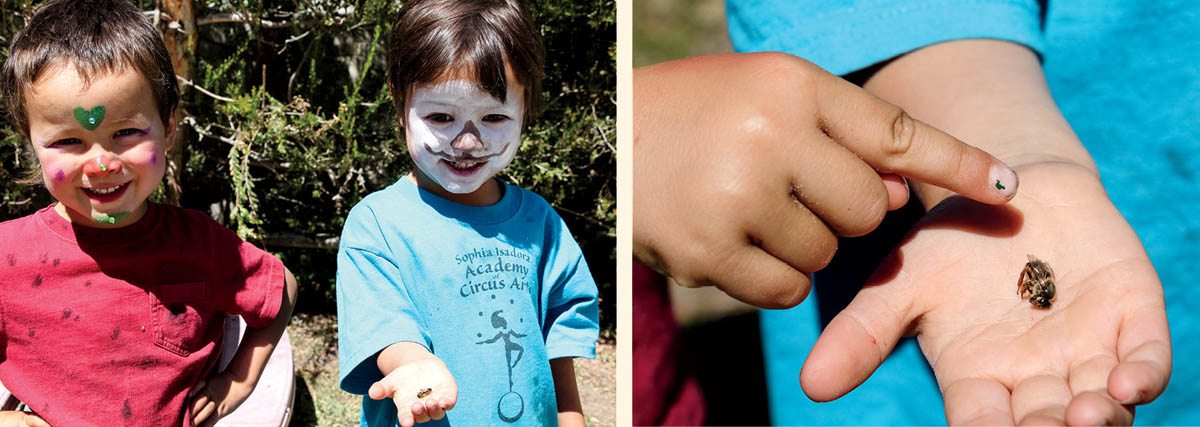 A pair of children holding a dead queen bee.