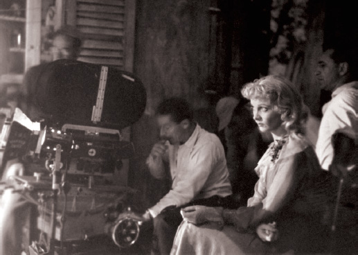 Vivien, in costume as Blanche DuBois, watches the action from behind the camera.