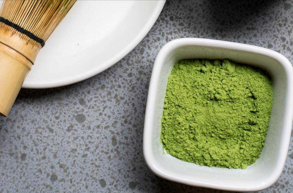 green powder in white bowl