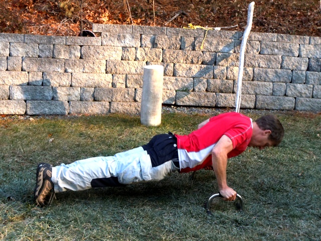 Doing pushups outside with pushup bars