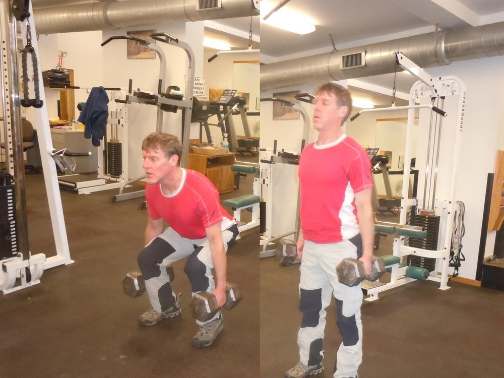 Performing a type of deadlift with dumbbells