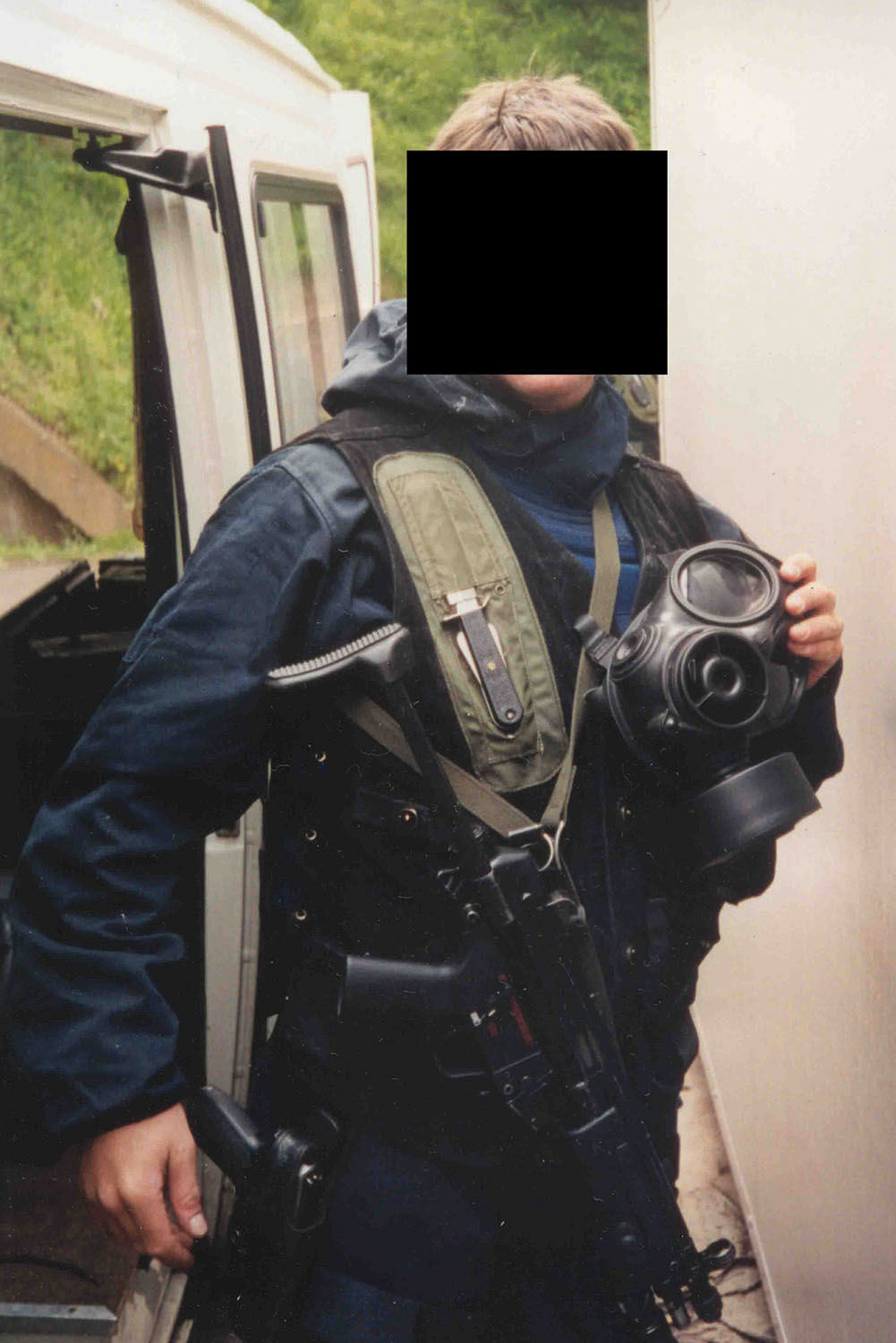 An SBS/SAS operator in CT gear prepares to assault ship – note gas mask, knife inverted on right chest, MP5 submachine gun and Sig Sauer pistol on hip.