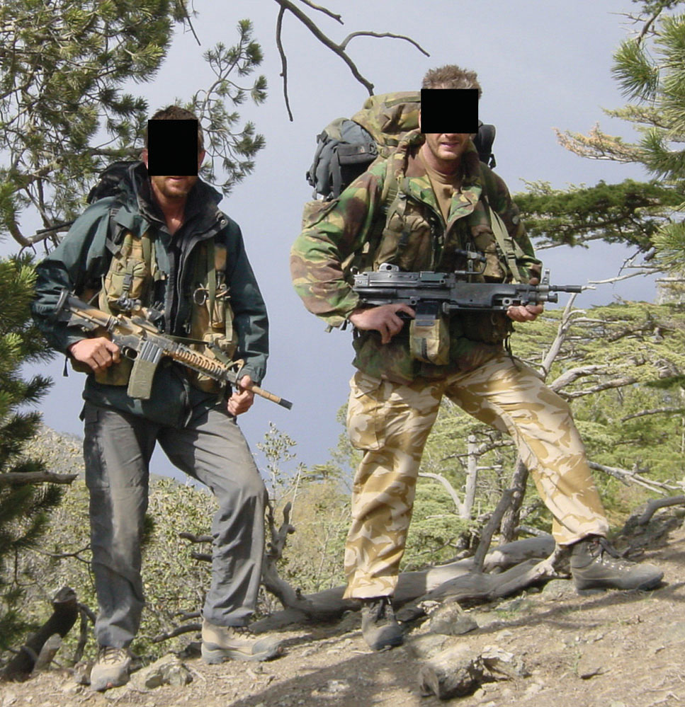 SBS troopers on climb into Naka OP, carrying 100-pound bergens and with Diemaco assault rifle and Minimi SAW machine gun held at the ready.