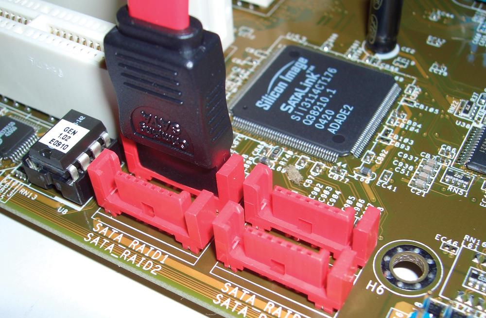 A group of four SATA data connectors on a motherboard, showing the L-shaped keying