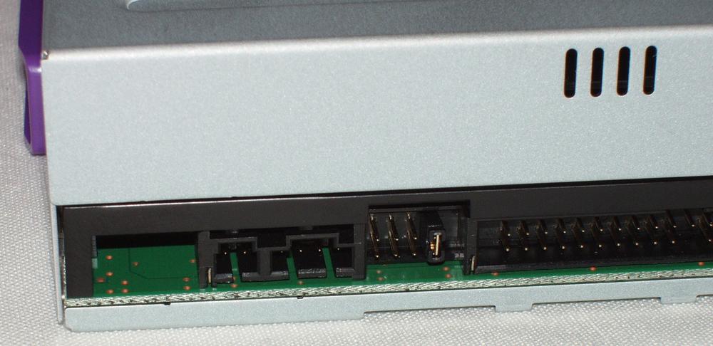 The rear panel of a DVD drive, showing the configuration jumper