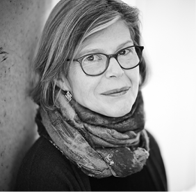 Headshot of author Carol Bruneau wearing glasses.