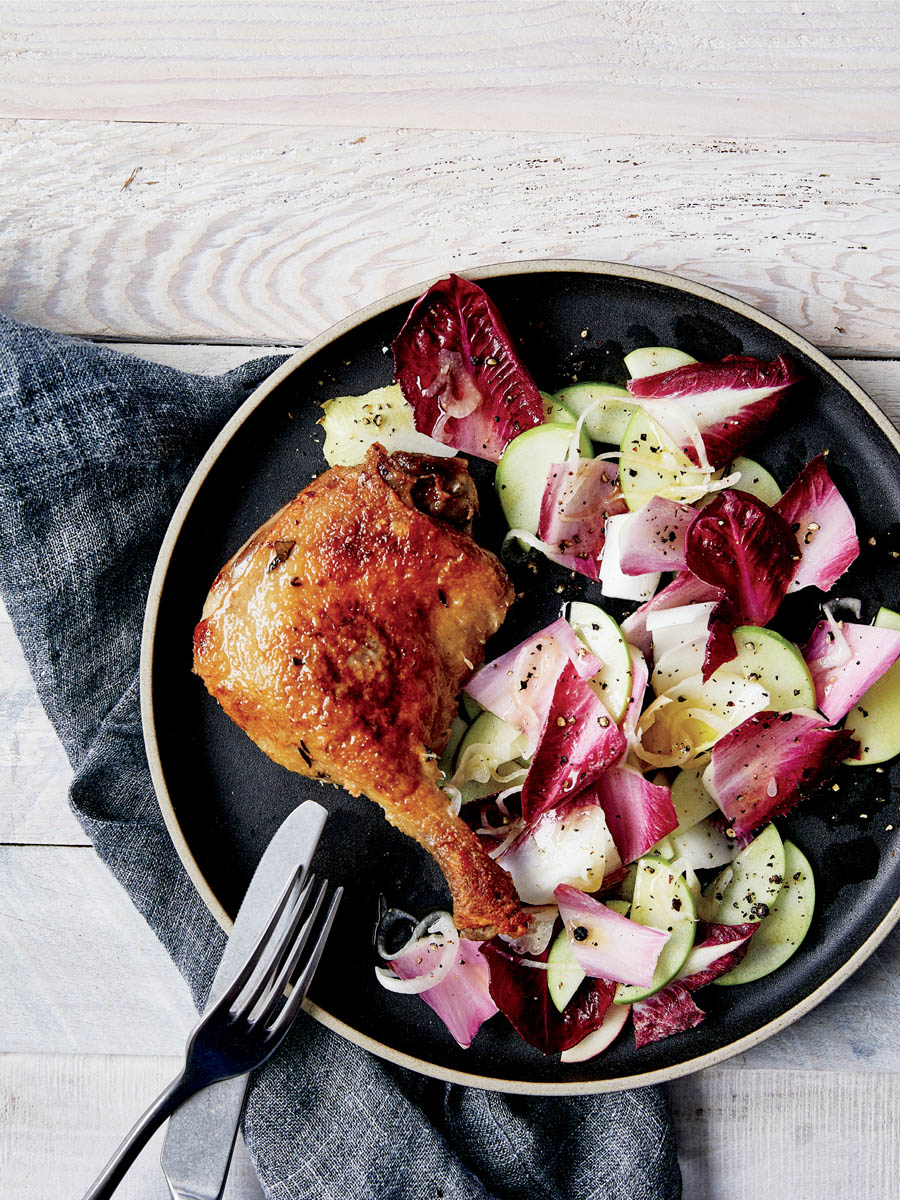 A plate of duck confit, endive, and apple salad.