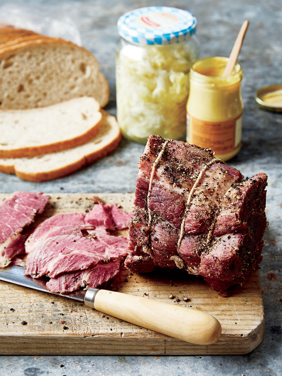 A beef brisket wrapped in string, seasoned with herbs. 