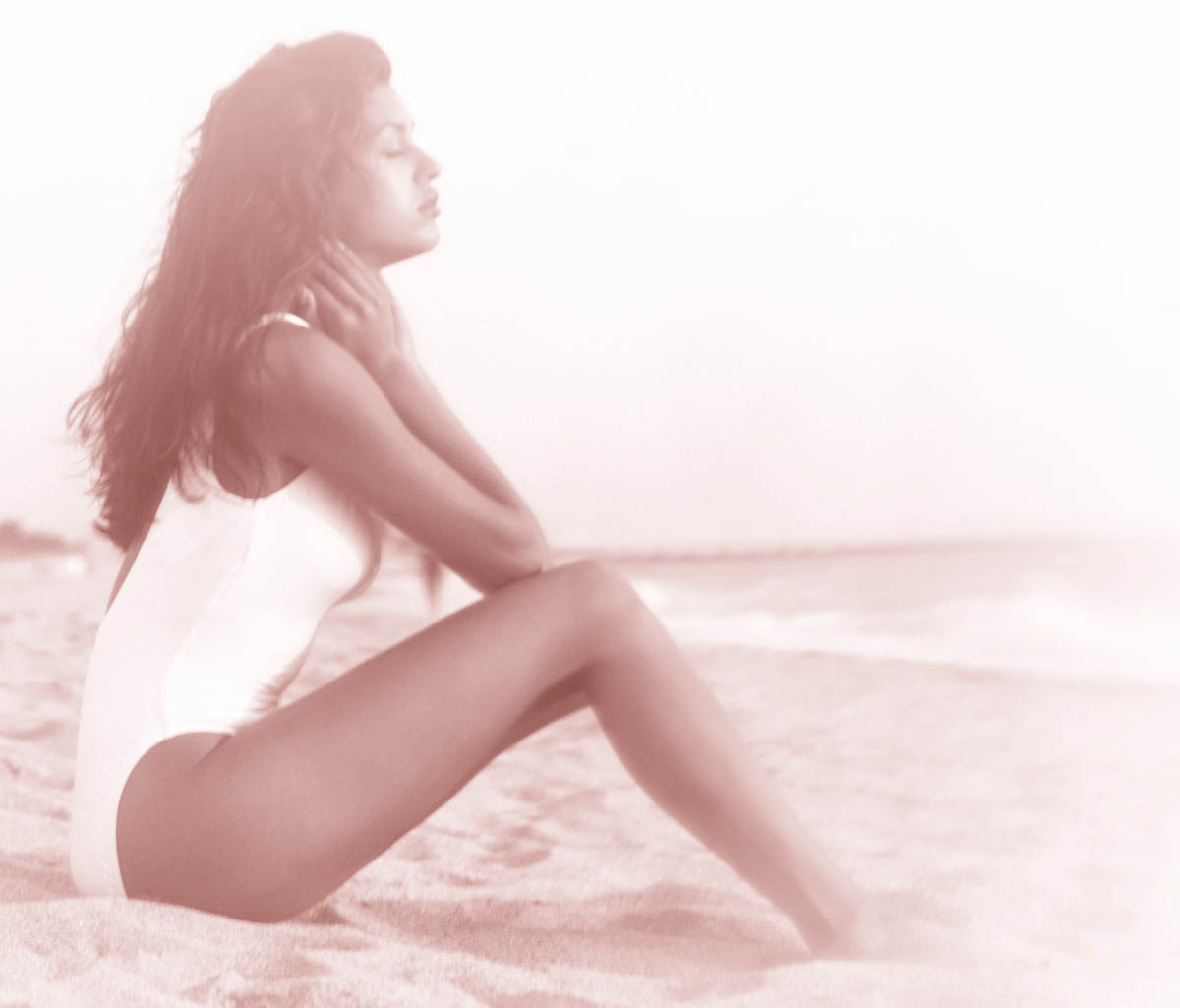 A woman relaxing on a beach.