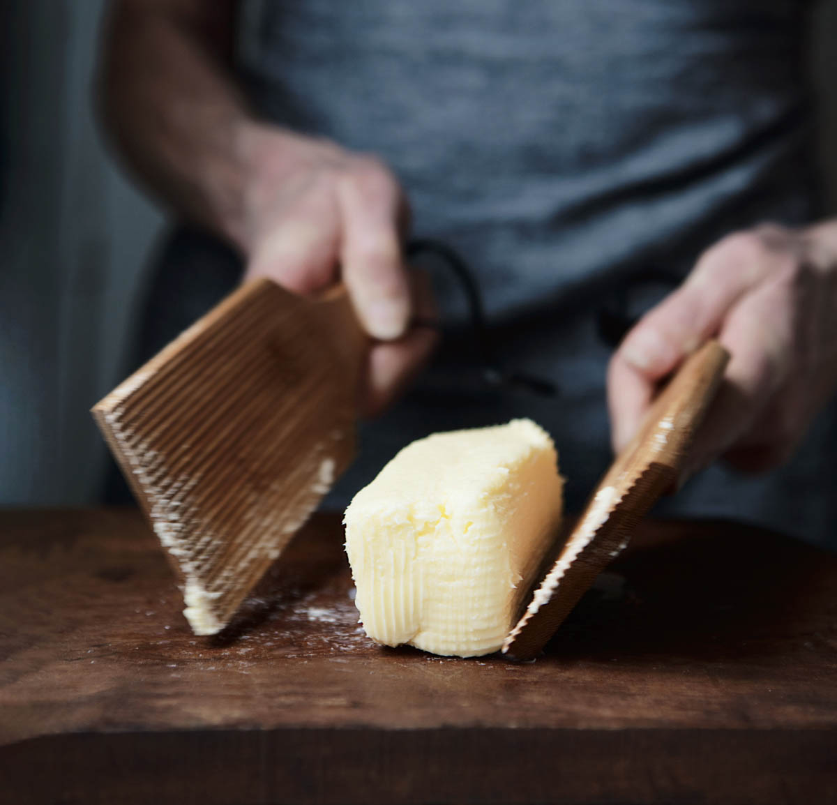 A chef shaping a stick of kefir butter