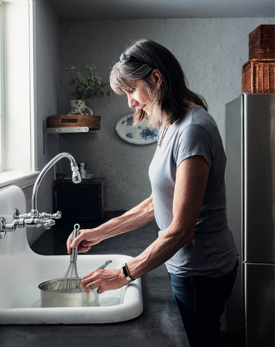 The author working in her kitchen at home