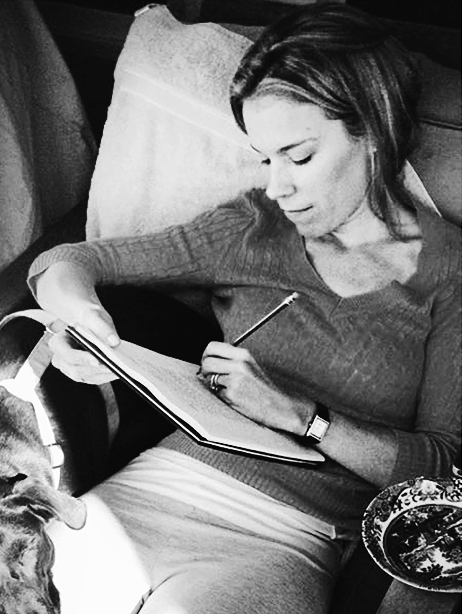 Alli works on the final edits of her first novel,  The Traitor’s Wife,  on the porch of their first apartment in Chicago.