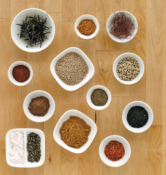 Various spices and seasonings, each in an individual small white dish