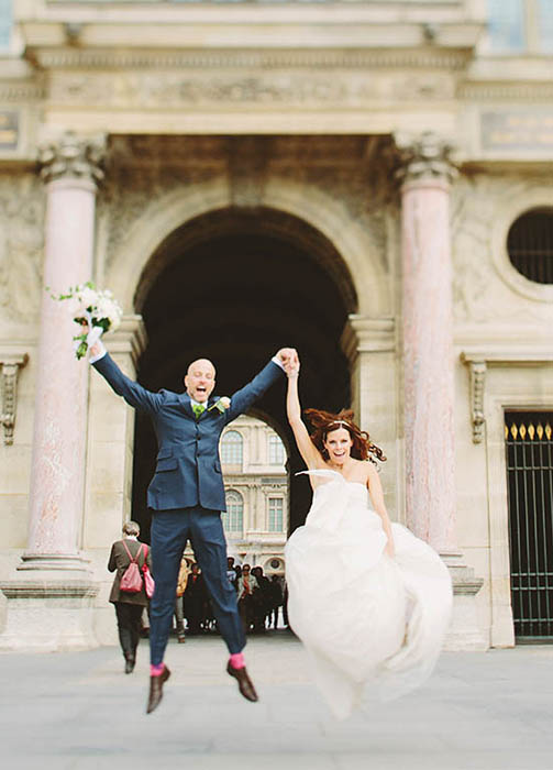 Photo of couple jumping.