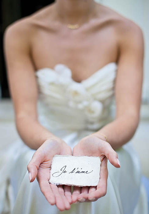 Photo of bride holding card.