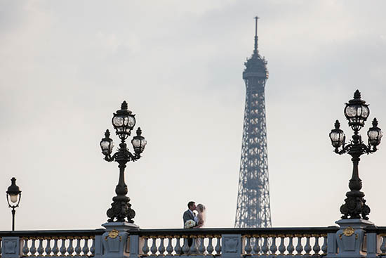 Photo of couple near Eiffel Tower.