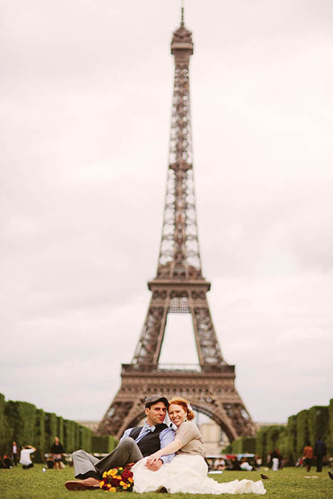 Photo of couple in front of Eiffel Tower.