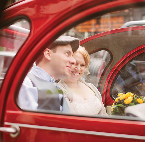 Photo of couple in red car.