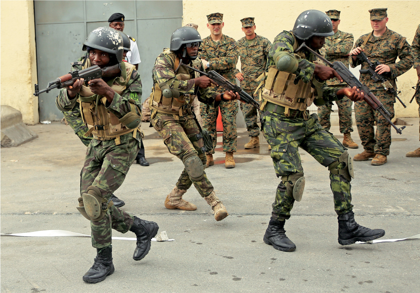 Angolan Marines, known as Fuzileiros Navais da Marinha de Guerra Angolana (MGA), practice  clearing a room in Luanda, Angola, March 4, 2015. U.S. Marines, British Royal Marines and Spanish Marines spent three days training with the Angolans in close-quarters combat, small boat operations and repair, and search and seizure techniques before departing for Cameroon during the maritime security exercise, Africa Partnership Station. (Official U.S. Marine Corps photo by Staff Sgt. Steve Cushman/Released)