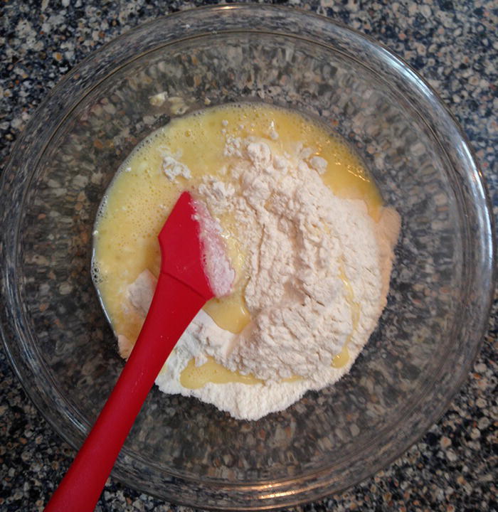 Photo of water, flour, and spatula in a bowl.