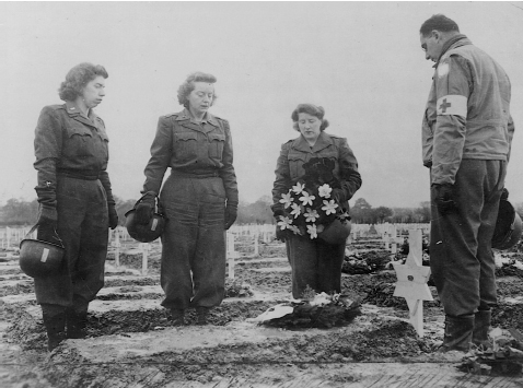 Army nurses of the 45th Field Hospital pay homage at the grave of 2nd Lt. Frances Y. Slanger USA at Henri-Chapelle Cemetery in Belgium. Courtesy of NARA