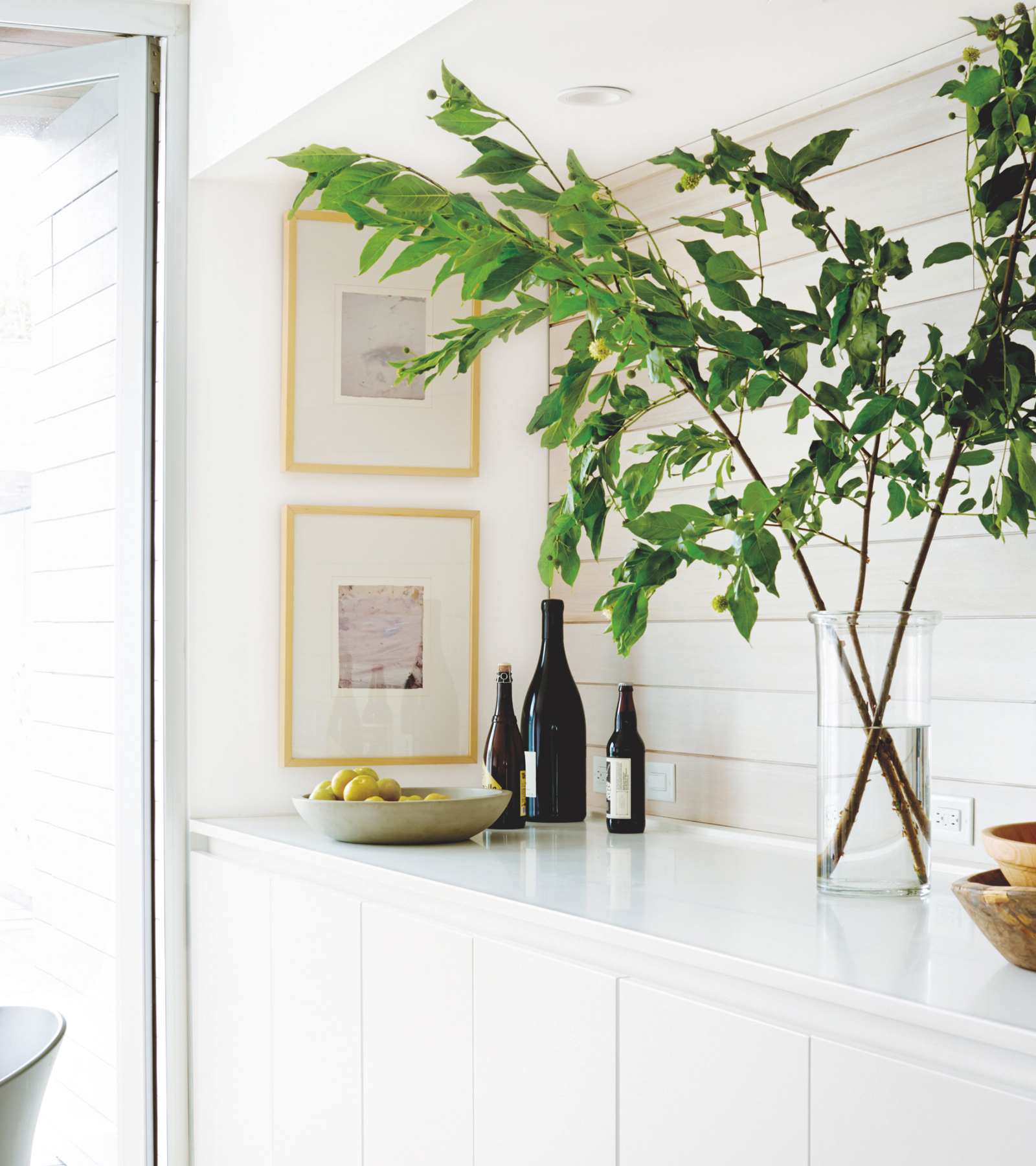 With so much white space between the counter and the ceiling, just a few branches are a natural fit, plus the stems add another wood tone to the mix. Don’t be afraid of stems—sometimes they can look messy but a few select branches will look simple.